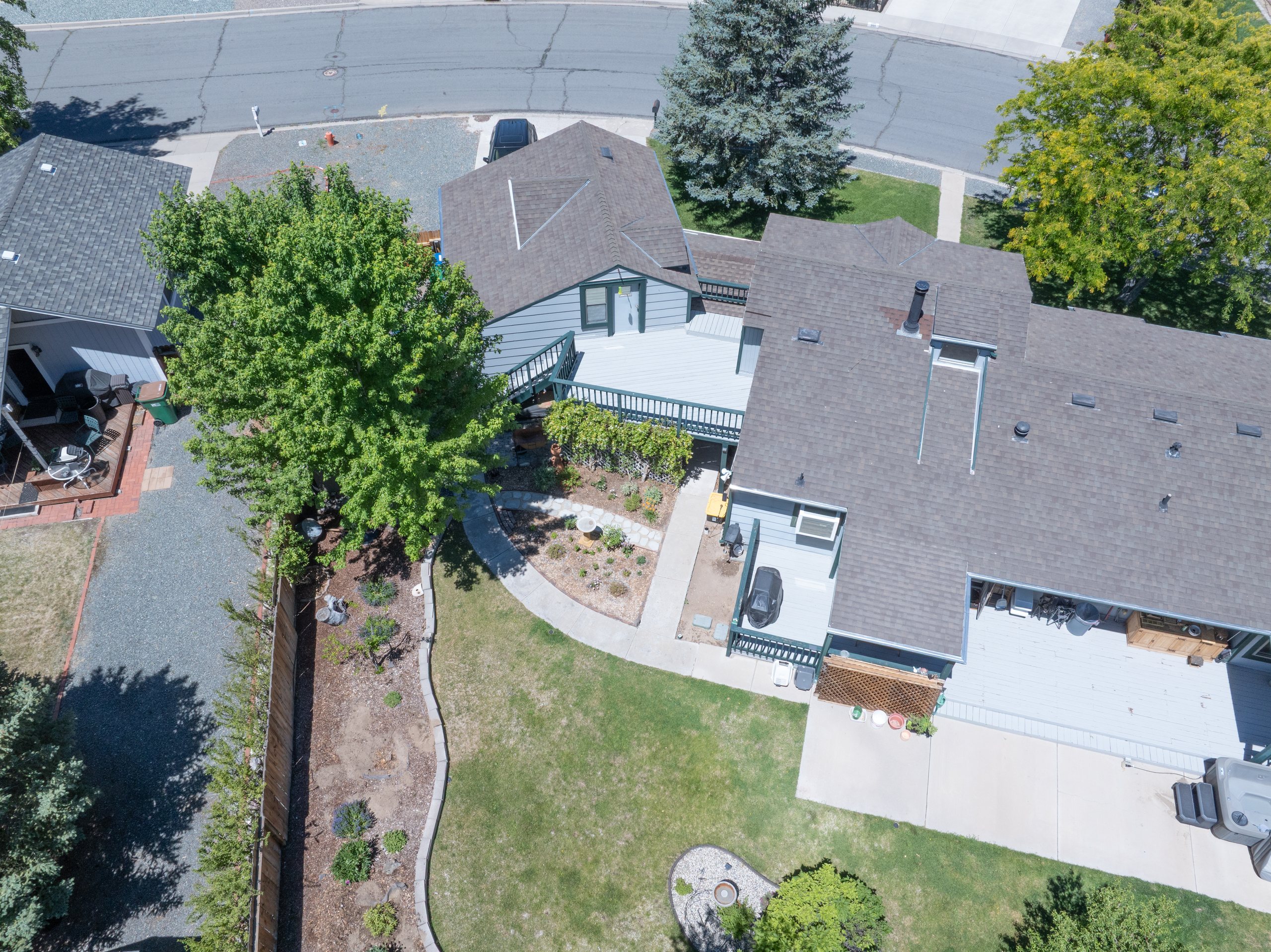 Low aerial showing decking, planting beds, and mature canopy at a residence, Carson City, Nevada