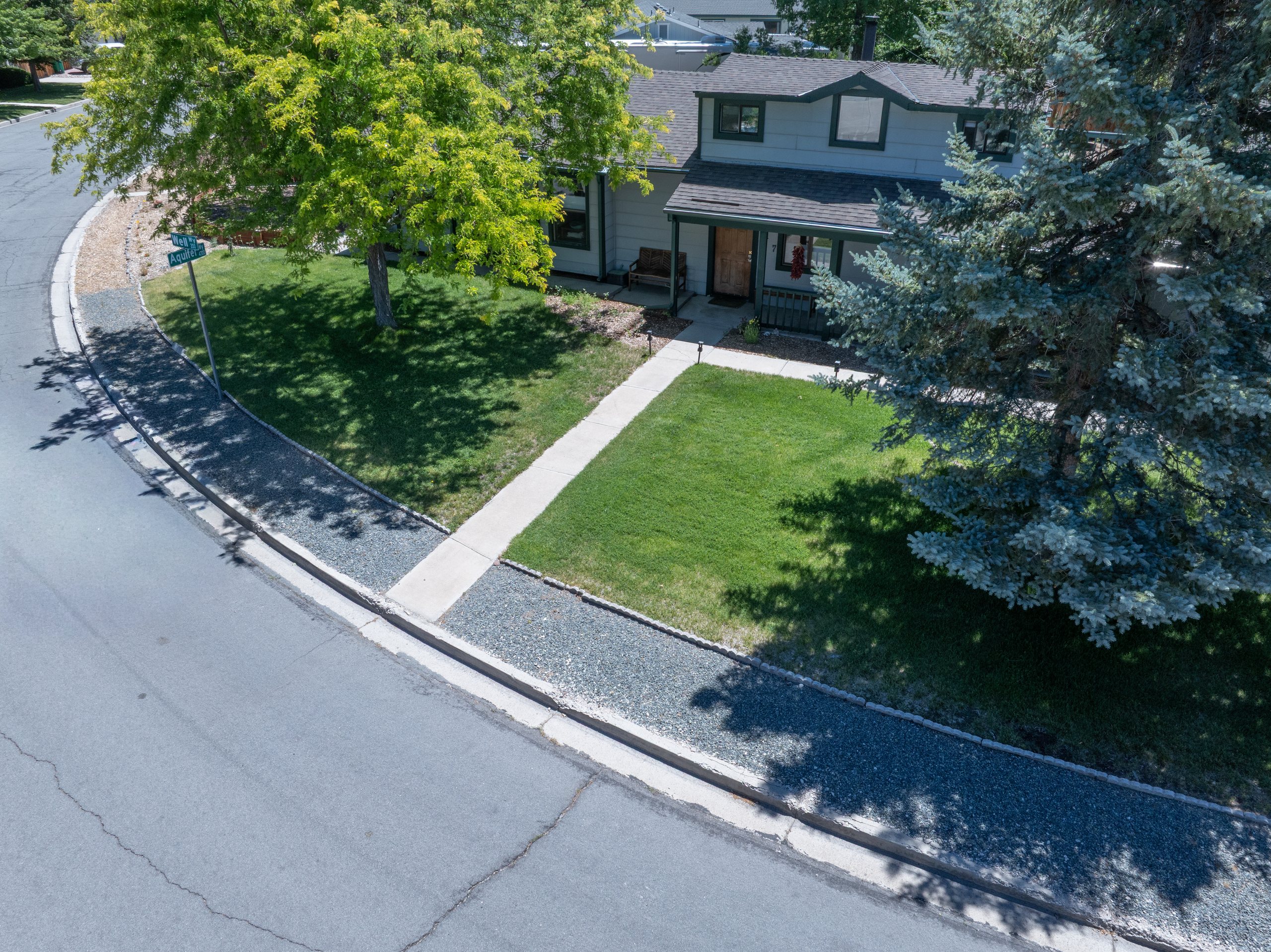 Low aerial of a front elevation and corner lot with mature trees, Carson City, Nevada