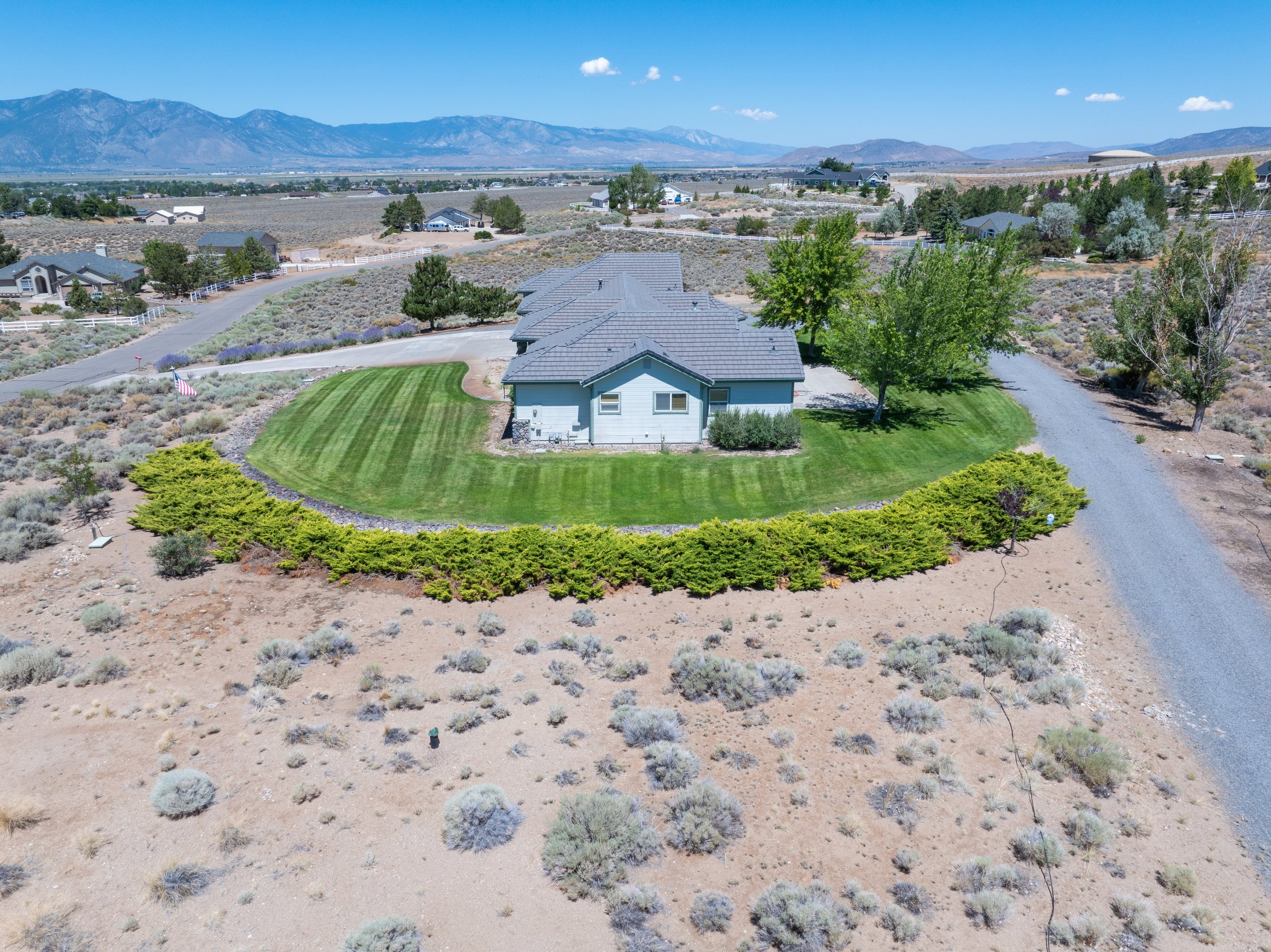 Aerial of the rear elevation with juniper border and Carson Valley beyond, Gardnerville, Nevada