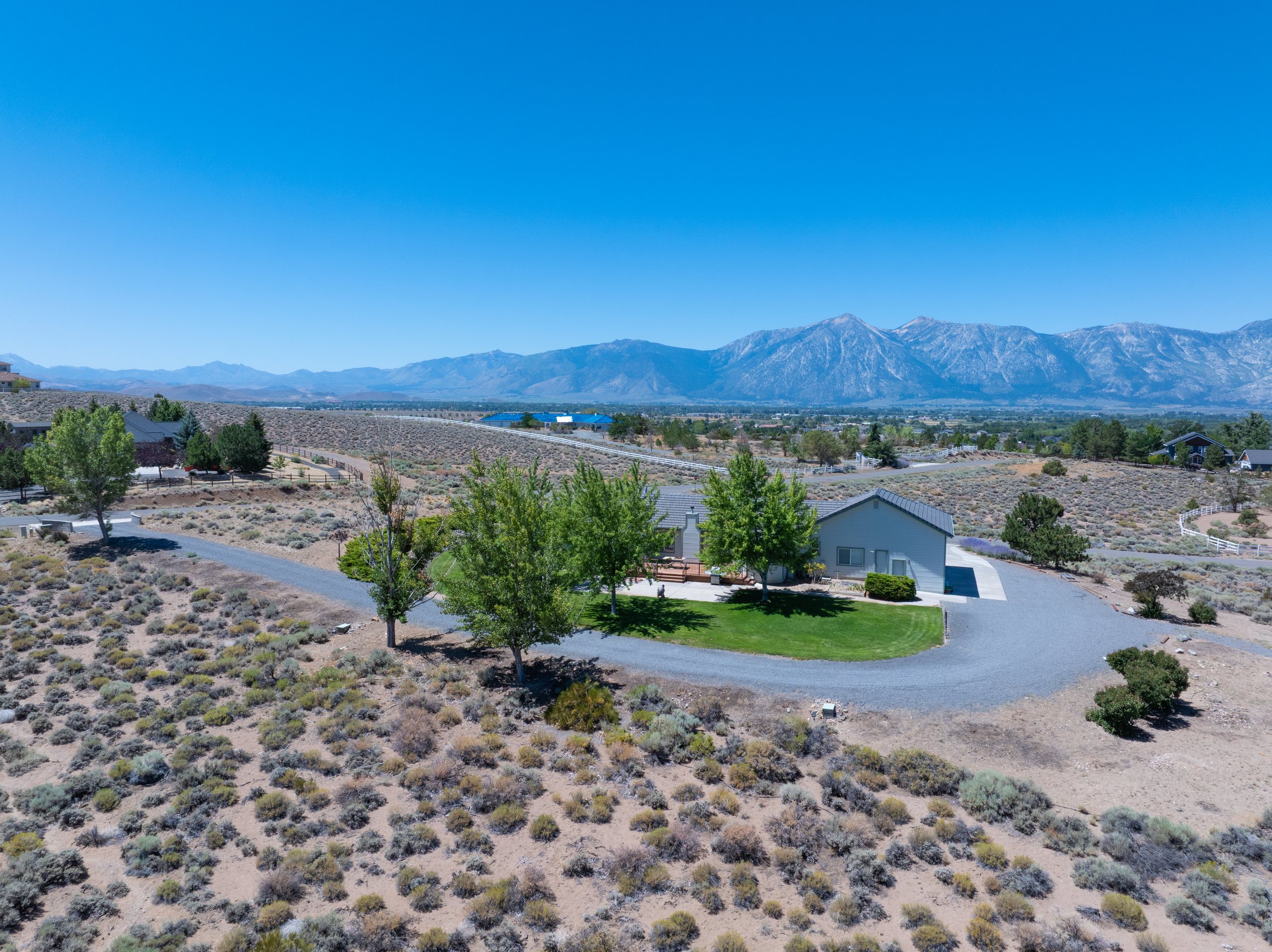 Aerial view of a single-story residence with the Carson Range beyond, Gardnerville, Nevada